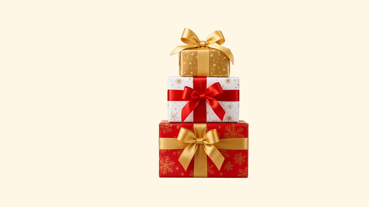 Stack of wrapped Christmas gift boxes with gold and red bows, transparent PNG